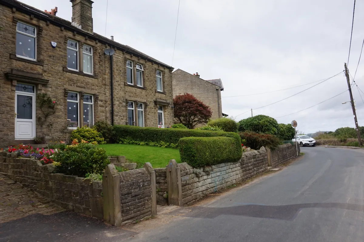 Stone houses with neat front gardens on Cartworth Road, Holmfirth